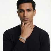 Elegant silver woven mesh bracelet with textured interlocked pattern and polished finish