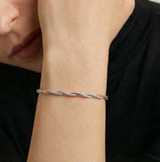 Rose gold and silver dual-tone twisted chain bracelet with sleek braided design and adjustable clasp