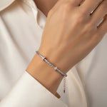 Twisted dual-tone mesh bracelet with rose gold crystal accents and woven metallic design for women.