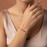 Elegant blush weave bracelet with crystal charm accents and adjustable clasp design