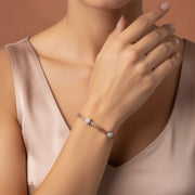 Elegant blush weave bracelet with crystal charm accents and adjustable clasp design