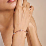Elegant blush weave bracelet with crystal charm accents and adjustable clasp design