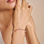 Elegant blush weave bracelet with crystal charm accents and adjustable clasp design