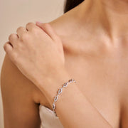 Elegant crystal wave link bracelet with sparkling curved links and adjustable chain closure