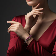 Elegant silver cuff bracelet with pink ruby stones in a modern wave design 