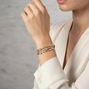 Triple tone mesh bracelet with gold silver and rose gold braided bands featuring crystal charm accents and clasp closure.