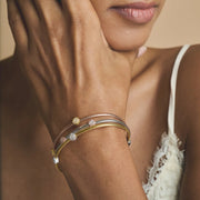 Triple tone mesh bracelet with gold silver and rose gold braided bands featuring crystal charm accents and clasp closure.