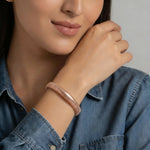 Minimal rose gold ribbed bracelet with textured finish and sleek modern clasp design