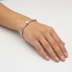 Rose gold woven mesh bracelet with crystal halo accents and elegant clasp design
