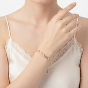 Rose gold bracelet with crystal heart charms and delicate adjustable chain design for women