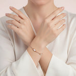 Minimal rose gold bracelet with rectangular mother pearl accents and crystal bar detailing on a delicate chain.