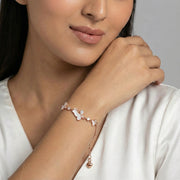 Rose gold cloud charm bracelet with white enamel cloud motifs and sparkling crystal stones on a delicate chain bracelet.