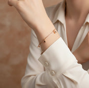 Minimal rose gold bracelet with dangling cube charms and delicate chain design for women