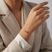 Minimal rose gold infinity loop bracelet with interlocked circular charm and sleek chain design