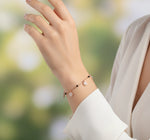 Rose gold charm bracelet with crystal floral charms and black bead chain detailing