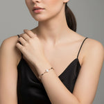 Elegant rose gold halo bracelet with crystal charms and black bead accents on a delicate chain design.
