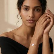 Rose gold bracelet with pearl-inspired round charm and sparkling star centrepiece
