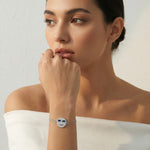 Silver smiley face charm bracelet with blue crystal sunglasses and sparkling stone detailing on a double chain bracelet.
