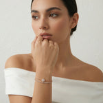 Rose gold double chain bracelet with floral crystal charm and delicate sparkling details 
