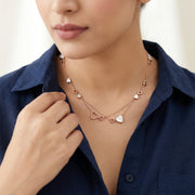 Rose gold layered heart necklace with white heart charms and delicate double chain design
