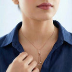 Minimal rose gold necklace with dual dangling crystal accents and delicate chain detailing
