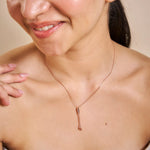 Minimal rose gold necklace with dual dangling crystal accents and delicate chain detailing
