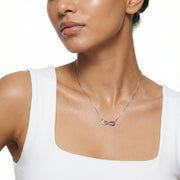 Rose gold infinity heart necklace with blue crystal accents and delicate heart charm design for women.
