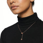 Minimal rose gold drop charm necklace with delicate chain and modern sliding pendant design
