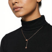 Minimal rose gold drop charm necklace with delicate chain and modern sliding pendant design
