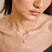 Rose gold layered necklace with sparkling clover charm and circular pendant design for women

