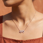 Rose gold infinity pendant necklace with sparkling crystal stones and delicate chain for women
