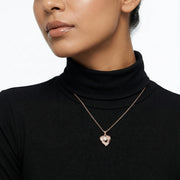 Rose gold heart pendant necklace with pearl centre and sparkling stone detailing on a delicate chain.
