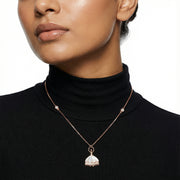 Rose gold ballet dress charm necklace with pink enamel pendant and crystal accents on a delicate chain.
