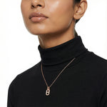 Rose gold lock pendant necklace with sparkling stone detailing on a delicate chain for elegant everyday wear.
