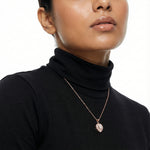 Elegant rose gold crystal heart pendant necklace with shimmering halo stones and geometric sparkle design.
