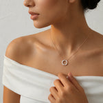Rose gold circle pendant necklace with sparkling crystal halo and modern minimalist chain design for women
