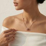 Rose gold barrel pendant necklace with crystal detailing and delicate chain
