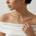 Rose gold heart pendant necklace with sparkling stones on a delicate chain
