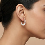 Elegant rose gold hoop earrings with white pearl inlay and modern open-circle design for women’s fashion jewellery.
