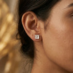 Rose gold clover stud earrings with white pearl enamel and crystal centre design
