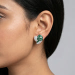 Emerald green heart-shaped stud earrings with sparkling crystal accents and luxurious silver-tone finish
