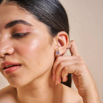 Square halo stud earrings with pink baguette stones and sparkling crystal border in silver finish.
