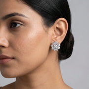 Luxury crystal snowflake stud earrings with floral halo design and sparkling white stones for women.
