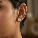 Pearl clover halo stud earrings with crystal border and glossy white centre design in gold finish.
