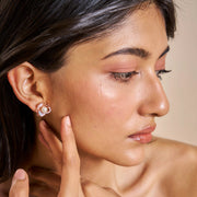 Rose gold floral pearl stud earrings with crystal accents and white enamel petals for women
