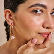Rose gold hoop earrings with round crystal pave disc design for elegant party and everyday wear.
