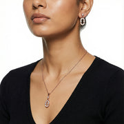 Rose gold oval pendant necklace and matching crystal earrings jewelry set for women with modern elegant design
