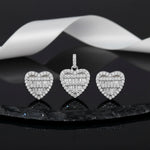 Crystal heart halo jewellery set with sparkling baguette stones featuring matching pendant and stud earrings in silver finish.
