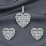 Crystal heart halo jewellery set with sparkling baguette stones featuring matching pendant and stud earrings in silver finish.
