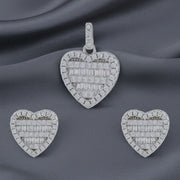Crystal heart halo jewellery set with sparkling baguette stones featuring matching pendant and stud earrings in silver finish.
